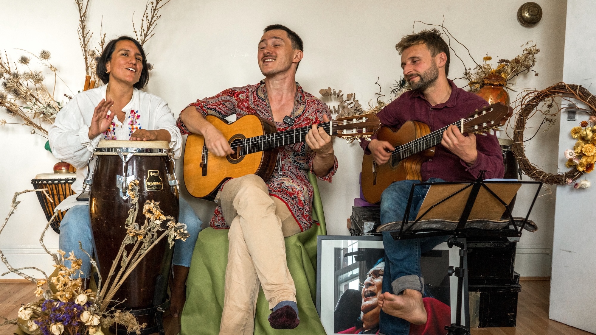 Vientos del Pueblo storytelling show performance featuring Alex Etchart with Pepa Duarte on vocals and cajón, and Alex Keeley on guitar, performing bilingual folk songs
